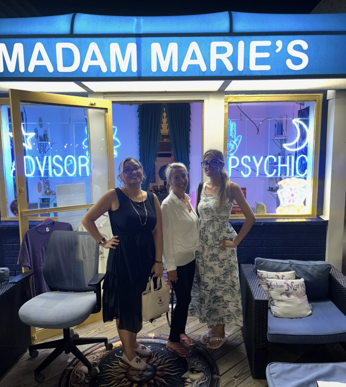 Madam Marie's family of readers beneath the glowing boardwalk sign